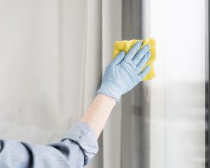 woman with rubber glove wiping window. Resolution and high quality beautiful photo